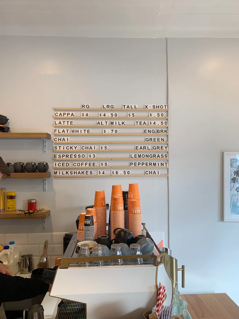 The drinks menu board inside Chimo café